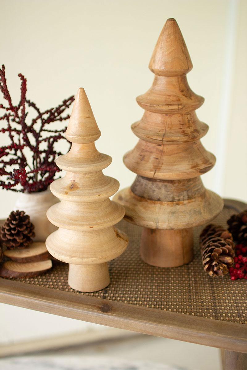 set of 2 mango wood turned trees - shown on coffee table with pine cones and mistletoe