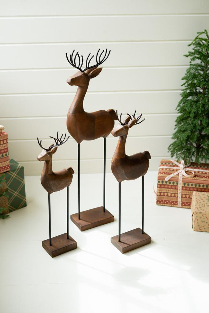 set of 3 carved wood reindeer on stands
