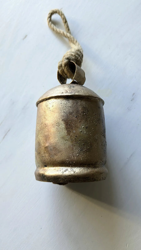 Bronze bell with a rope on a white background