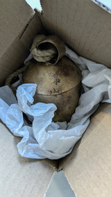 Photo of carefully wrapped and packaged bell in cardboard box with tissue paper