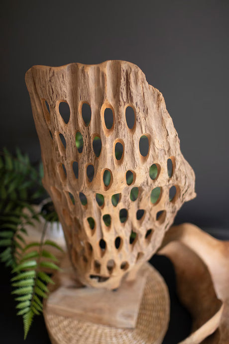 Wooden decorative piece with lattice design on a dark background
