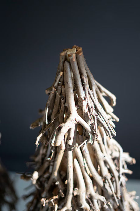 Driftwood sculpture against a dark background