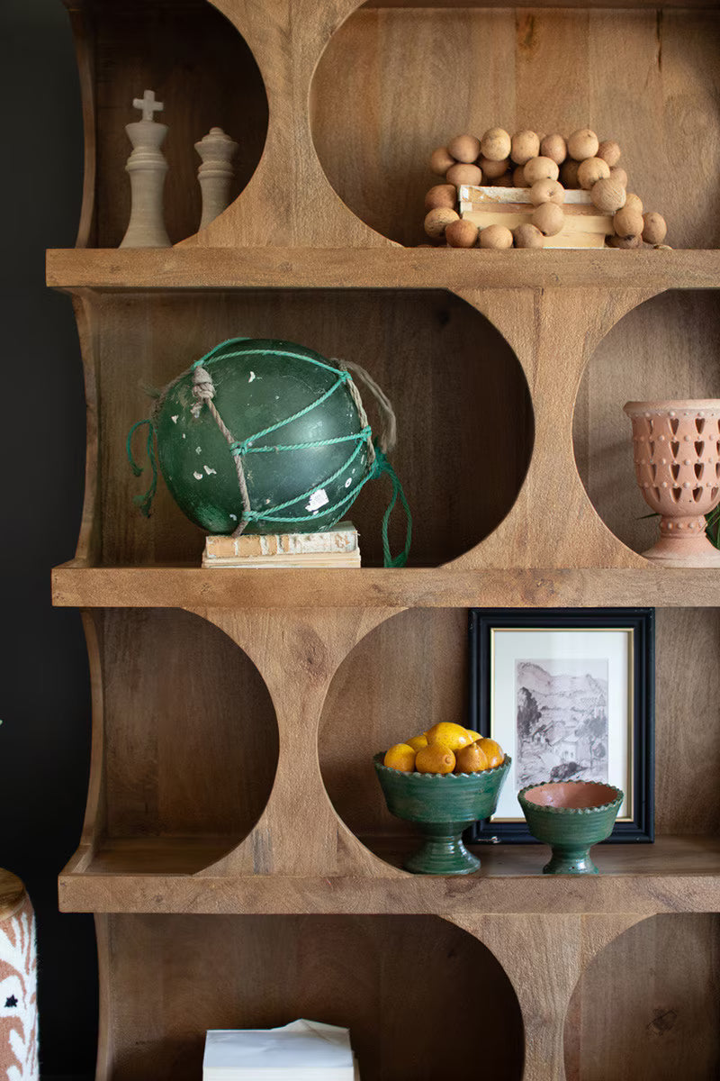 Wooden shelf with decorative items including a green globe, fruit bowl, and framed picture - zoomed view