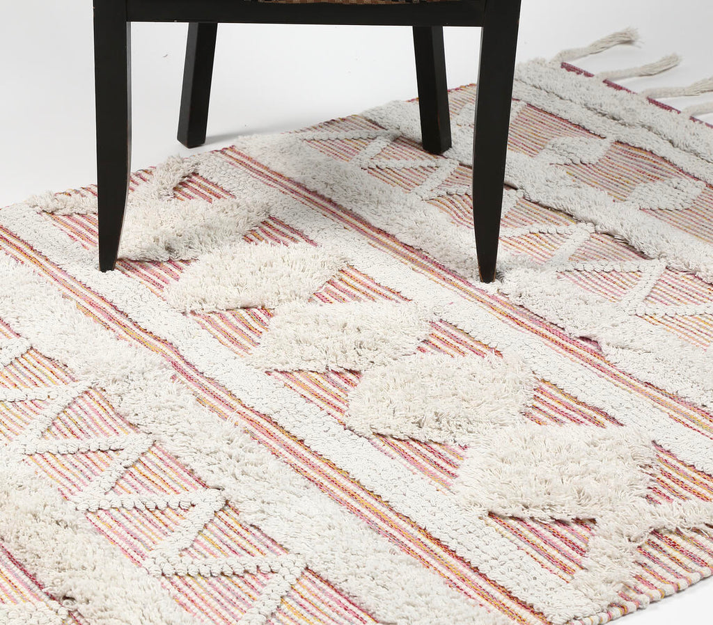 pink and white tufted statement rug