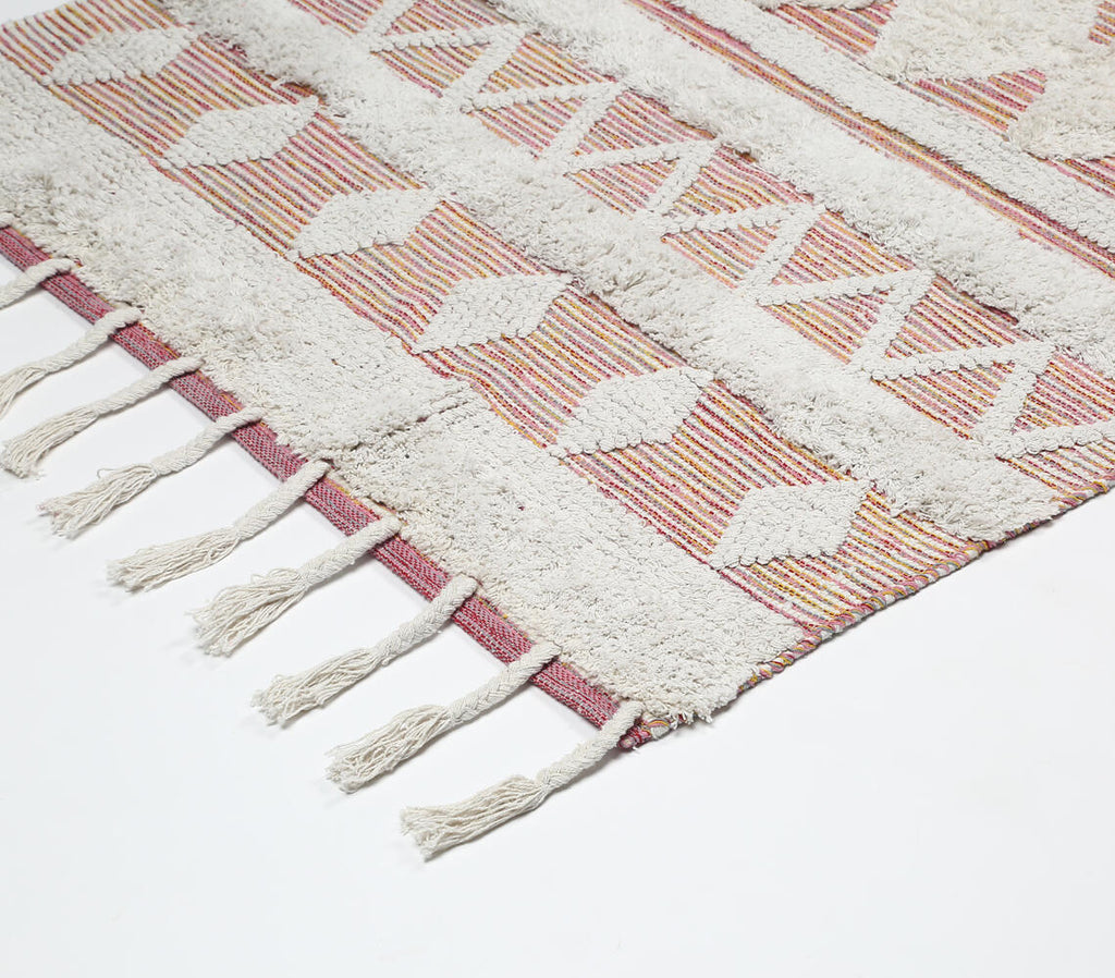 pink and white tufted statement rug - close-up of weave and tassel corner