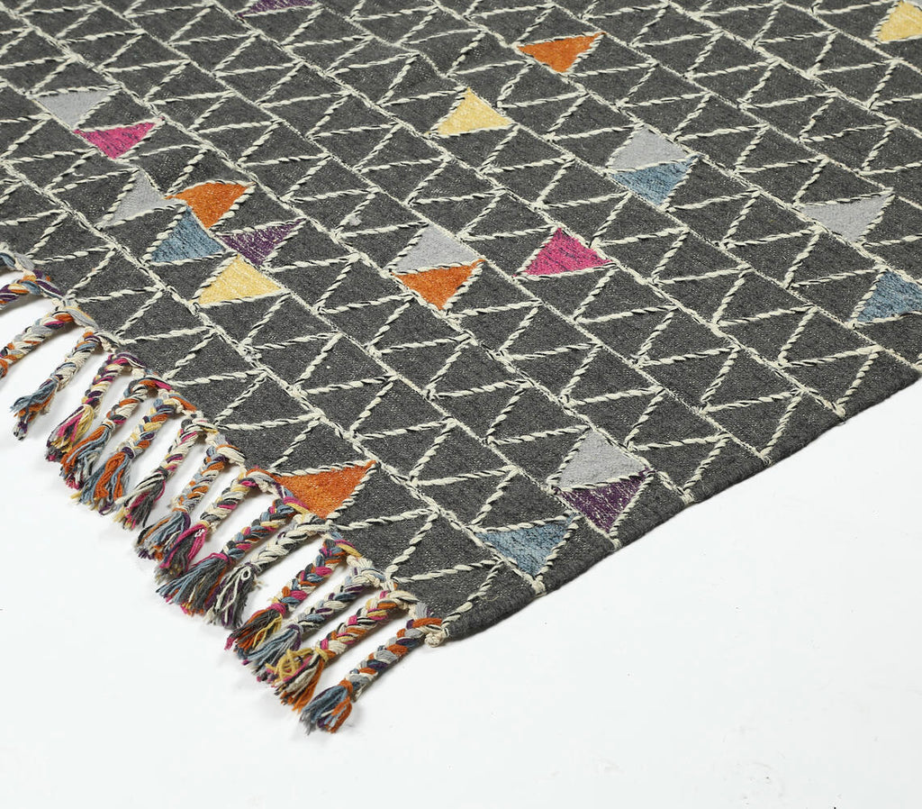 wool rug with color pop triangle design - close-up of tassle corner and weaving details