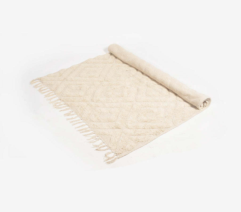 diamond patterned beige rug with tassels