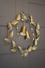 brass wreath with 2 bells wall decor - slightly angled perspective