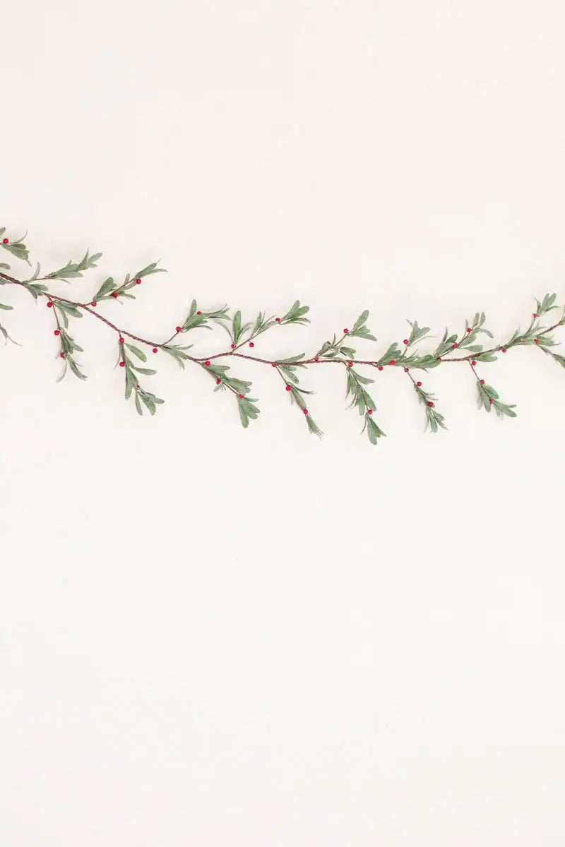 faux mistletoe garland hanging on white wall