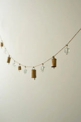 brass bells and glass bead garland hanging