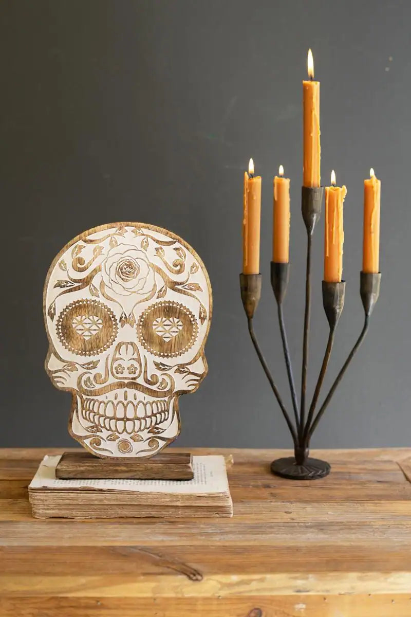 wood skull standing next to candles - the latter sold separately