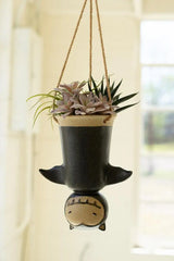 upside down hanging bat planter suspended by twine - a few inches away