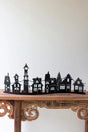 black silhouette city scape table decor - atop wood shelf