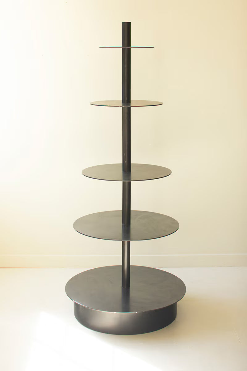Black metal display stand with 5 round shelves against white background