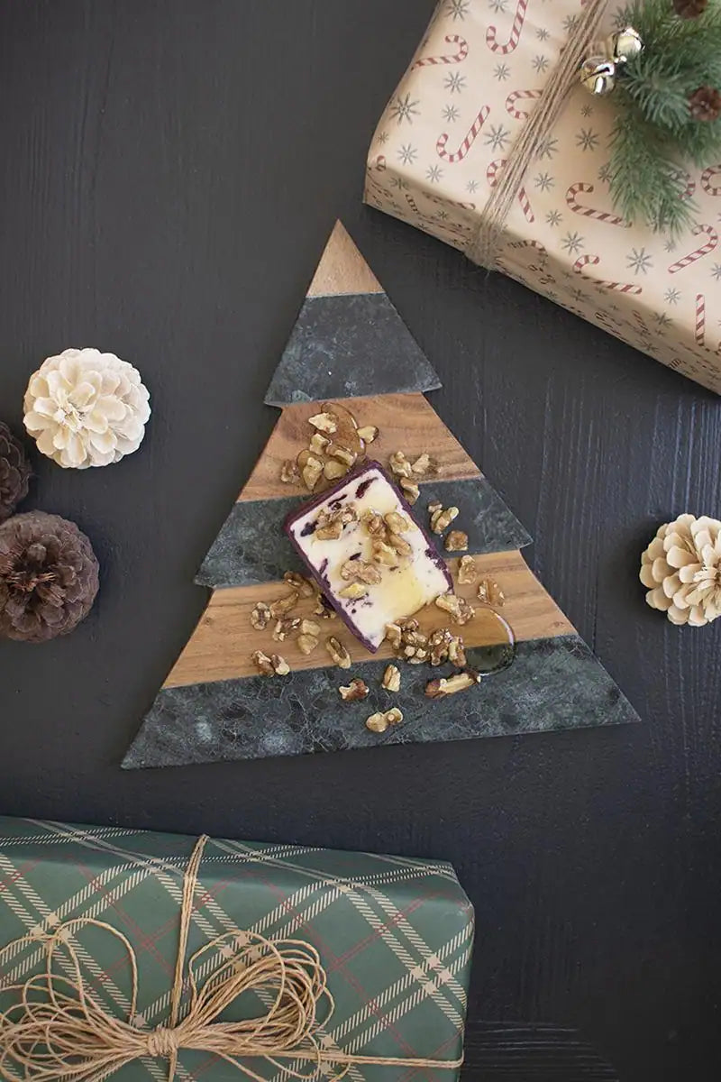 christmas tree shaped cutting board with food and presents around it - view is straight down