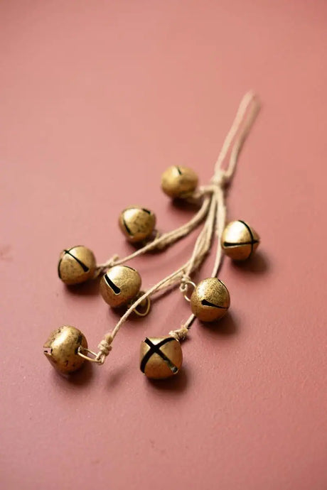 bunch of bells on jute ropes lying on orange brown surface
