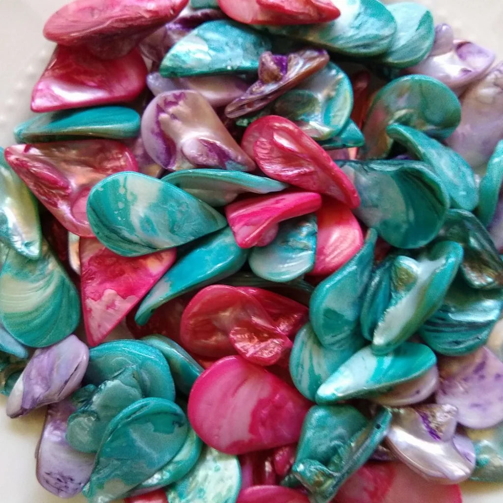 collection of tear drop shaped, mother-of-pearl beads, dyed in fuchsia, lilac and blue