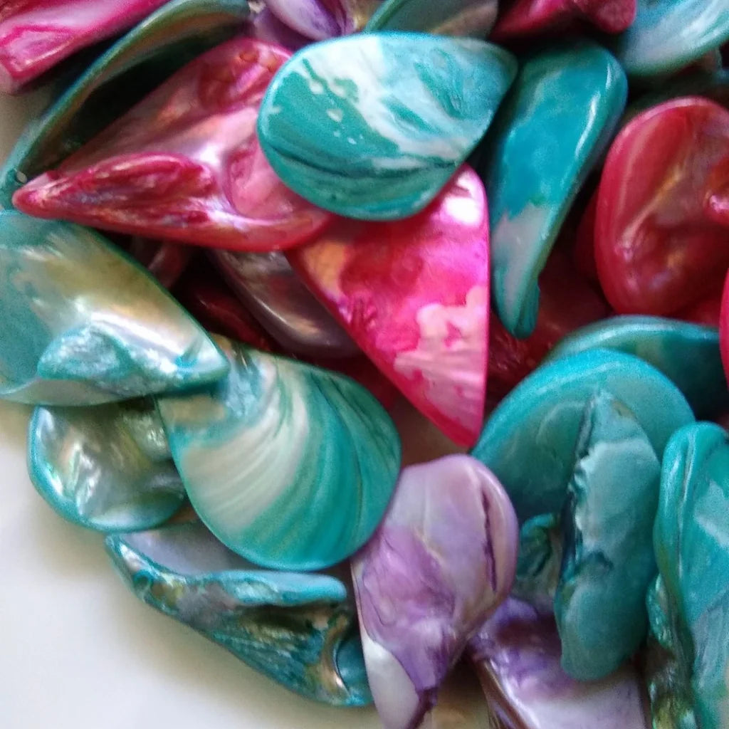 collection of tear drop shaped, mother-of-pearl beads, dyed in fuchsia, lilac and blue - close-up 3