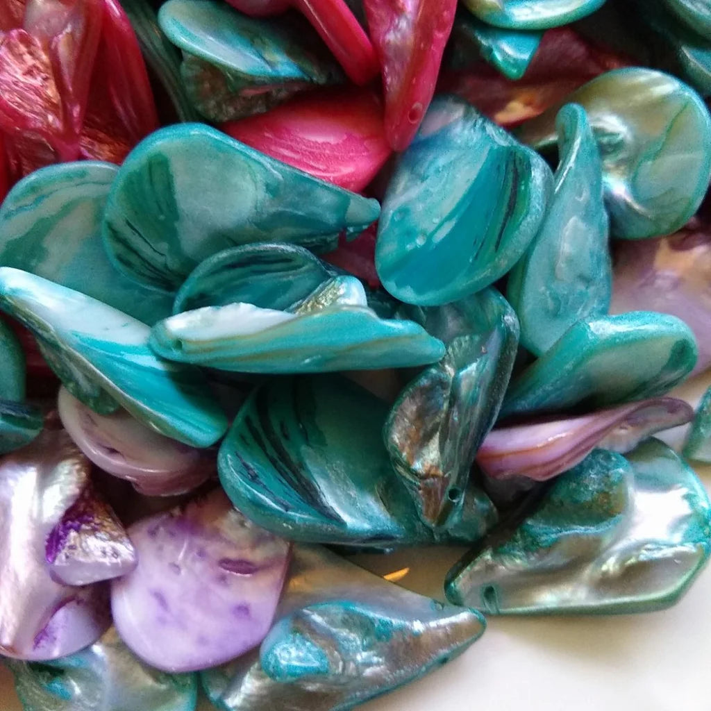 collection of tear drop shaped, mother-of-pearl beads, dyed in fuchsia, lilac and blue - close-up 2