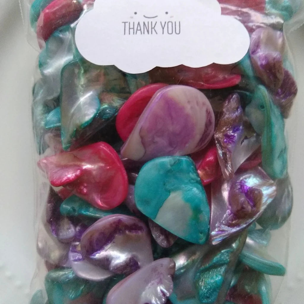 collection of tear drop shaped, mother-of-pearl beads, dyed in fuchsia, lilac and blue - in plastic bag ready to ship - smiling thank you sticker