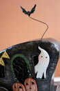 close up of the ghost in the window and the bat on top - halloween decor