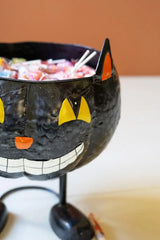 close up of black cat faced candy bowl