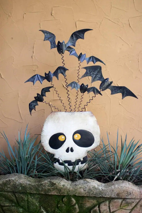 metal halloween skull with bats flying out of its head