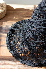 close up of black twigs - shaped into witch's hat