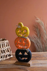 yellow orange and black jack-o-lanterns made of wood stacked on top of each other