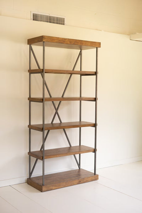 Thick pine wood bookshelf with metal frame against a white wall at an angle