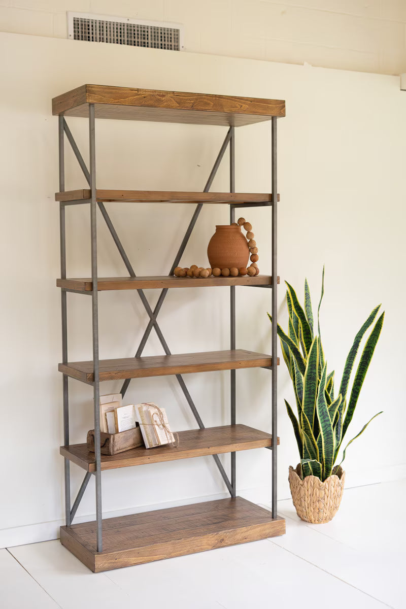 Angled view of metal framed wood shelving unit with plant and decorative items.