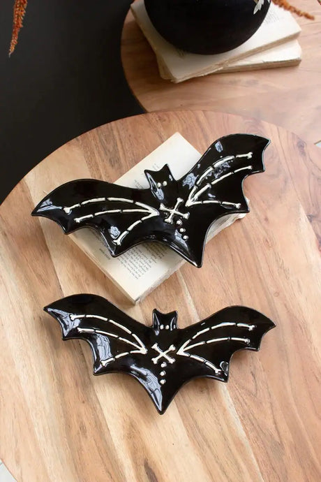 2 black ceramic bat platters with white bones detail