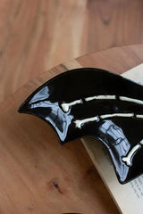 2 black ceramic bat platters with white bones detail - close up of left wing