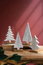 whitewashed carved wood christmas trees on stands