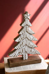 close up of carved whitewashed christmas tree with star on top