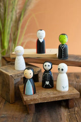 all 6 spook family figures each standing on a wood pedestal of varying height