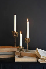 3 taper candle holders showing lit candles