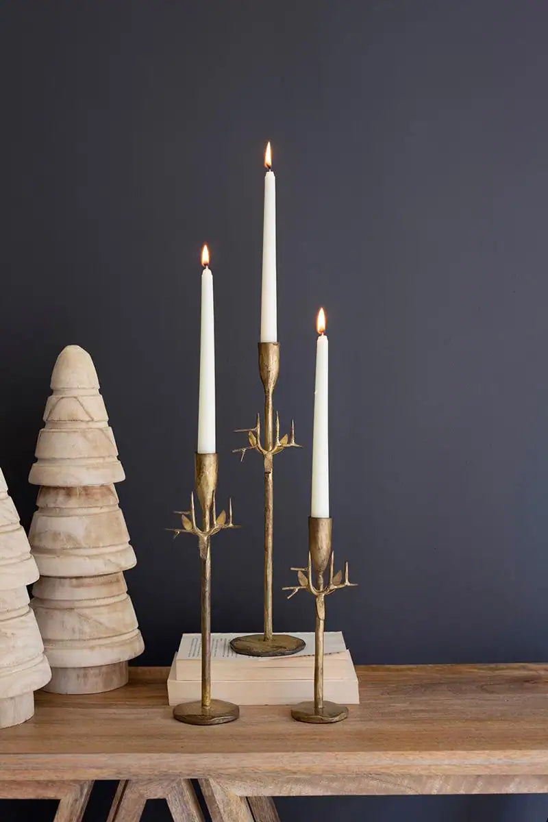 all 3 taper holders looking festive with tall burning white candles