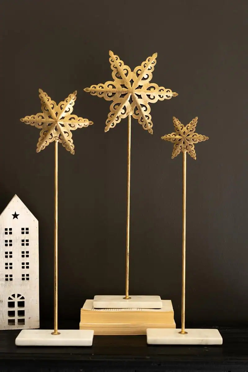 3 metal stars on thin poles with marble base