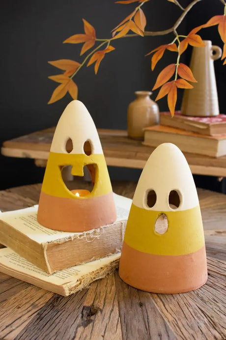 2 candy corn lanterns - 3 color tones white light green and tan - one with single tooth smile - another with a O facial expression