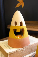 close up of single tooth smiling candy corn lantern