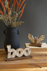 carved word boo and a separately carved bat both with halloween spirit motif