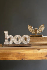 level frontal perspective of carved word boo and bat in background