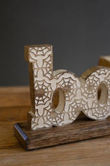 close up of carved word boo with its spider detail motif - halloween decor