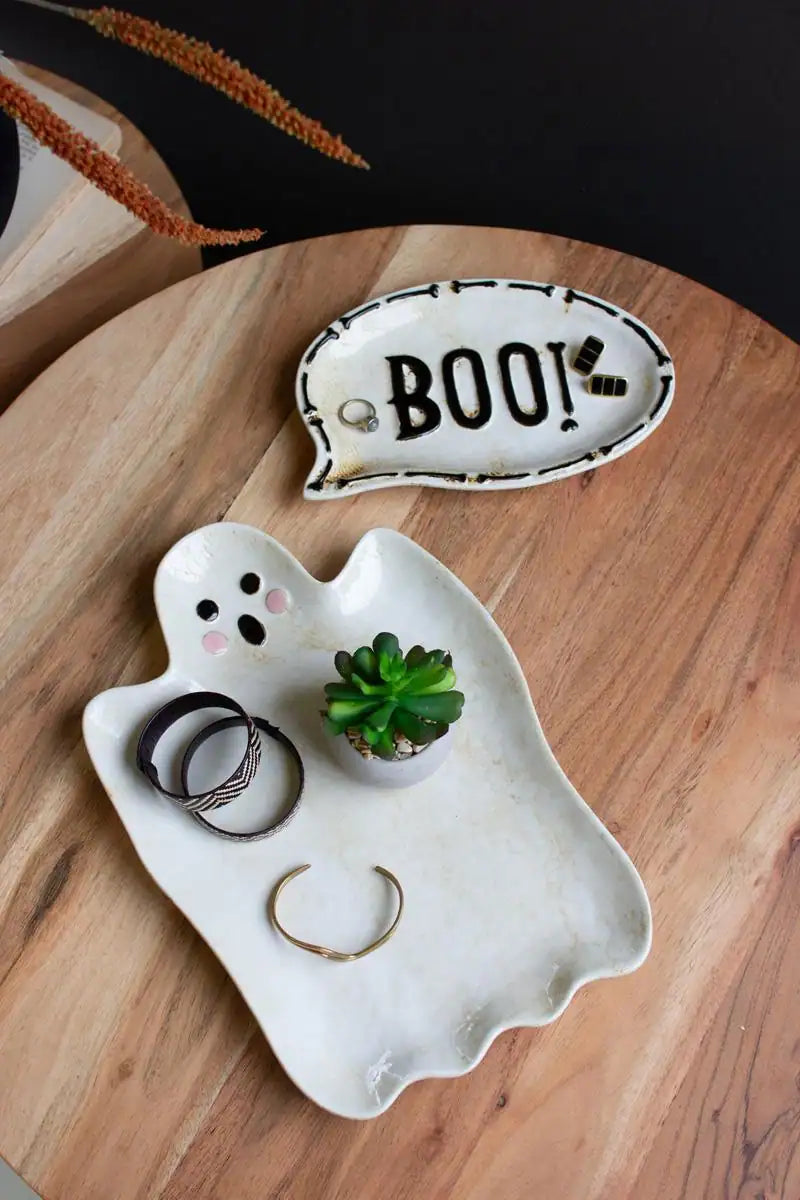 white ghost shaped ceramic platter with separate oval platter showing BOO! - showing here holding some small jewelry and a small plant