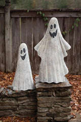 2 white ghosts - both smiling - the tall one has 4 teeth - the small one has black smile