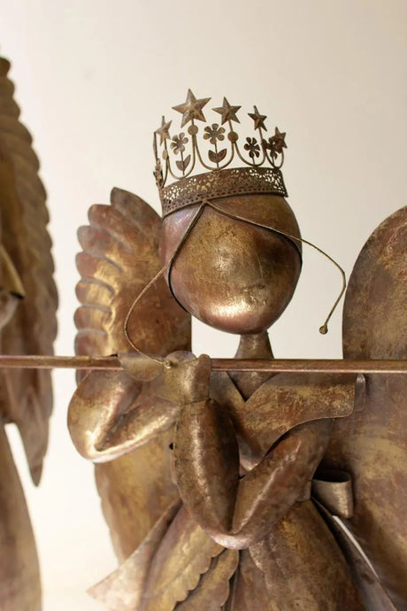 close-up of the crowned angel playing the flute