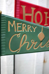 close up of green pennant with Merry Christmas in gold letters; red pennant in background with words Ho Ho Ho in gold letters