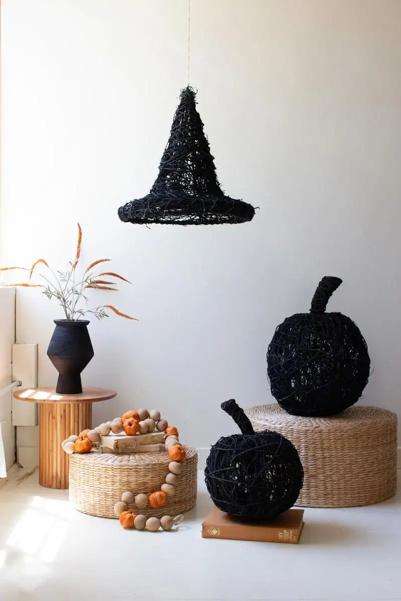 two black twig pumpkins along with a black twig witch's hat hanging from the ceiling by a string - the latter sold separately