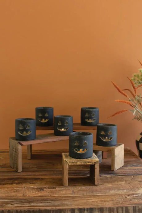 short cylindrial black clay smiling jack-o-lantern